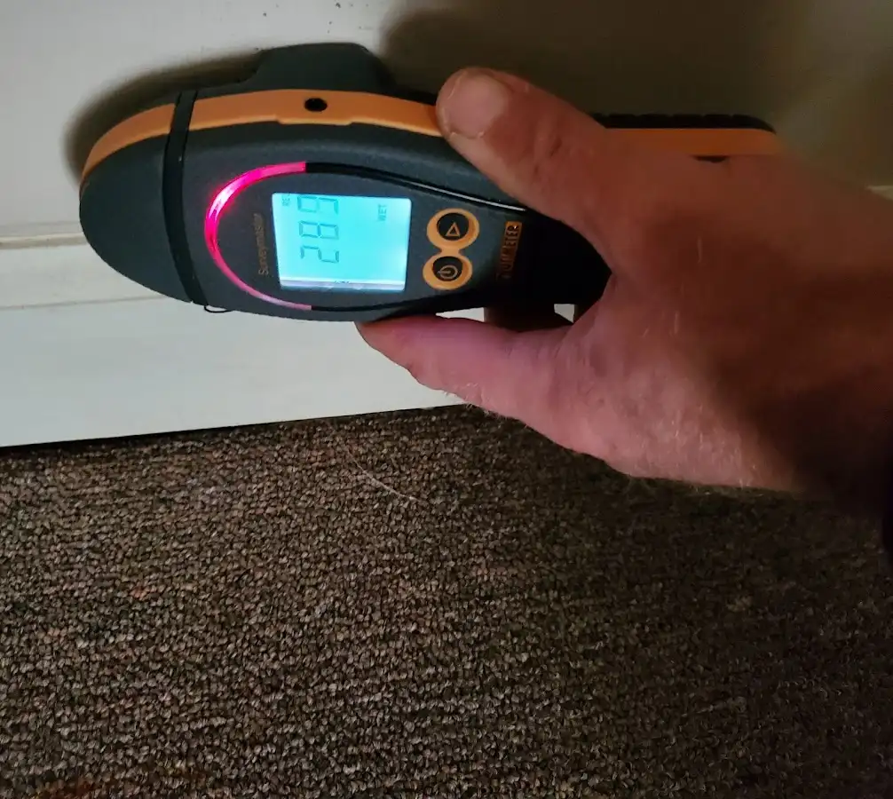 Moisture detection at baseboard during Storm Damage Restoration in Medford